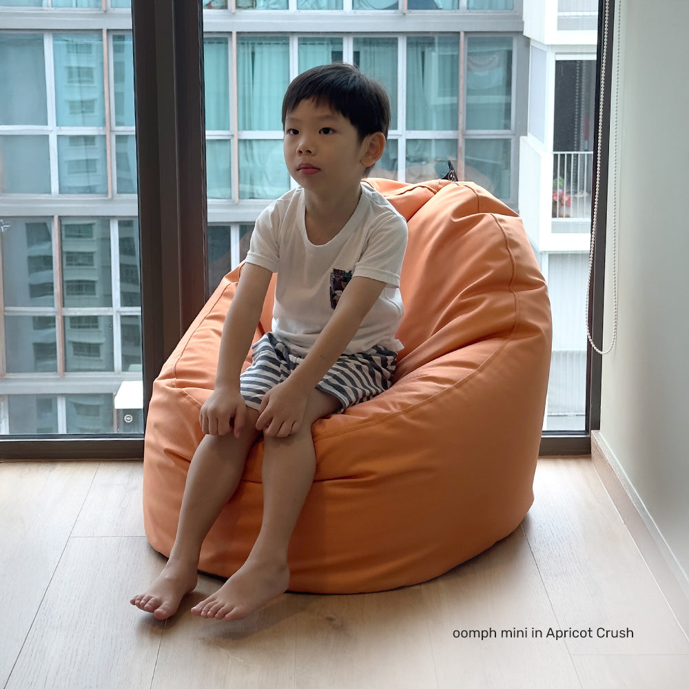 boy kid seating on a water-repellent bean bag chair in a kids room